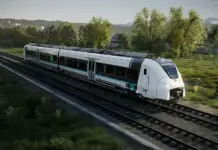 Siemens to Deliver Romania’s First Hydrogen-Powered Train Fleet High-speed white passenger train with teal accents traveling along tracks through a green rural landscape.