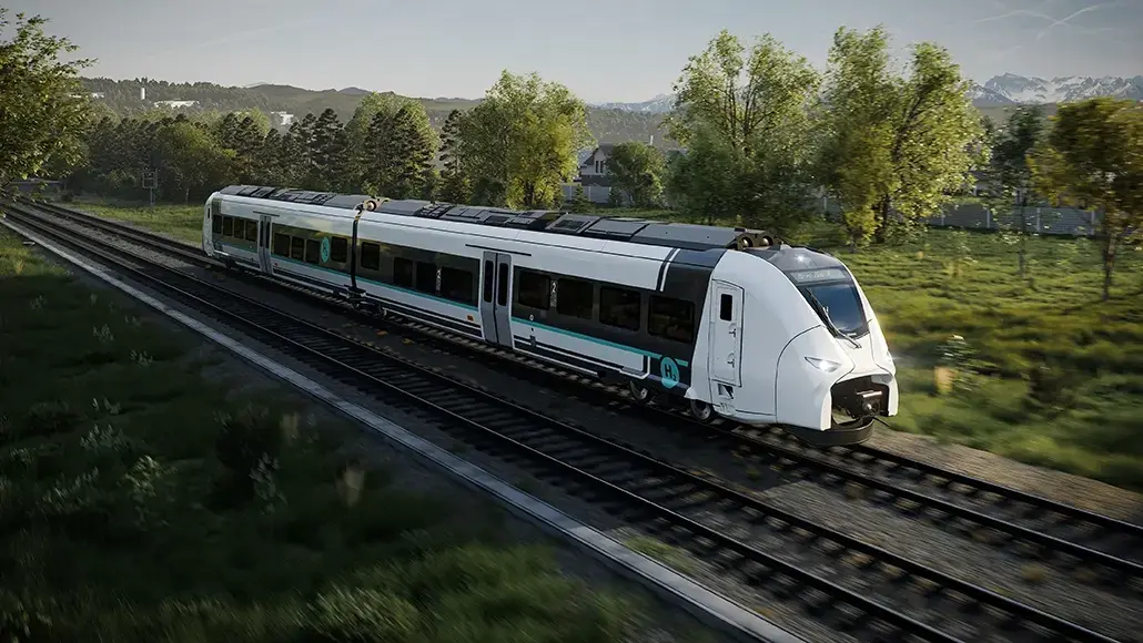 High-speed white passenger train with teal accents traveling along tracks through a green rural landscape.