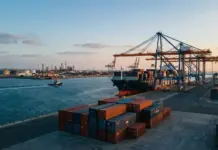 CMA CGM, Asyad Sign Multipurpose Logistics Terminal Deal Container ship docked at a busy port with towering gantry cranes and stacked shipping containers