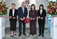 Qatar Airways Cargo, AAHK Ink Deal to Boost Air Connectivity Ribbon-cutting ceremony with four professionals cutting a red ribbon in front of a Qatar Cargo backdrop.