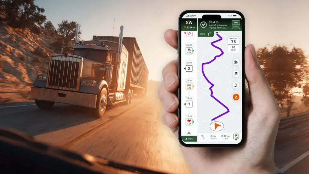 Truck driving on a sunset-lit highway while a person holds a smartphone showing a winding GPS route on the map.